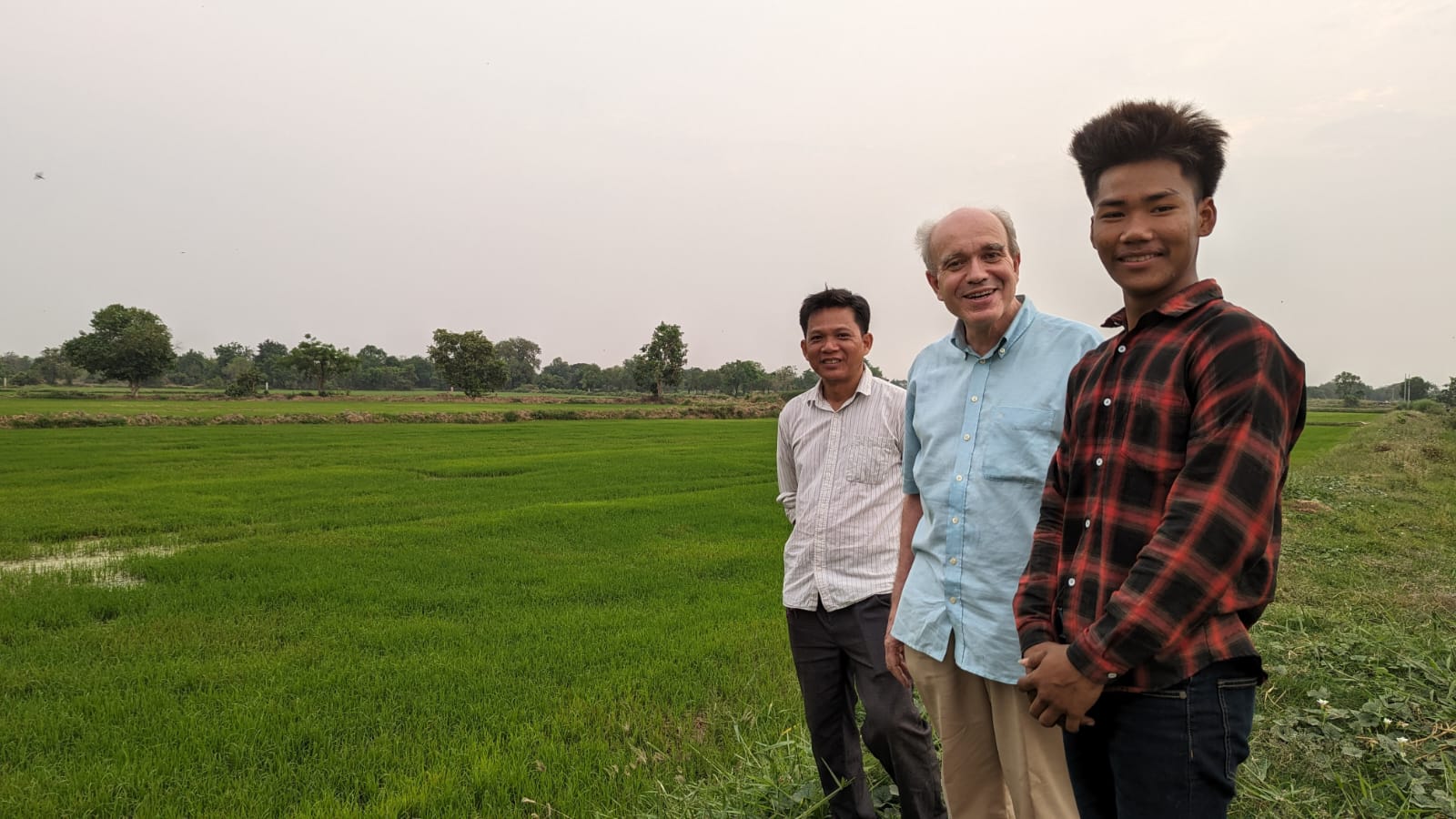 a group of men standing in a field
